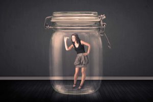 Businesswoman,Trapped,Into,A,Glass,Jar,Concept,On,Background